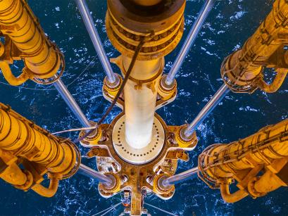 legs of an oil well going into the water