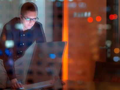 Man in building looking at a computer