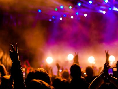 Crowd at concert with colorful stage lights