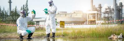 Two people taking water samples in dangerous zone