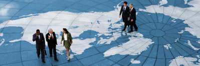 Professionals networking and collaborating together on an image of a world map